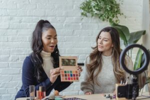 Inclusive women influencers doing makeup review in front of the camera