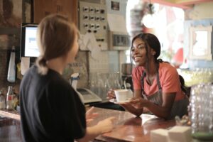 black woman small business owner offering coffee